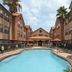 Homewood Suites by Hilton Houston - Woodlands courtyard pool with palm trees and orange umbrellas