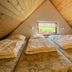 Grindsted Aktiv Camping attic room with three beds and a small window in Grindsted