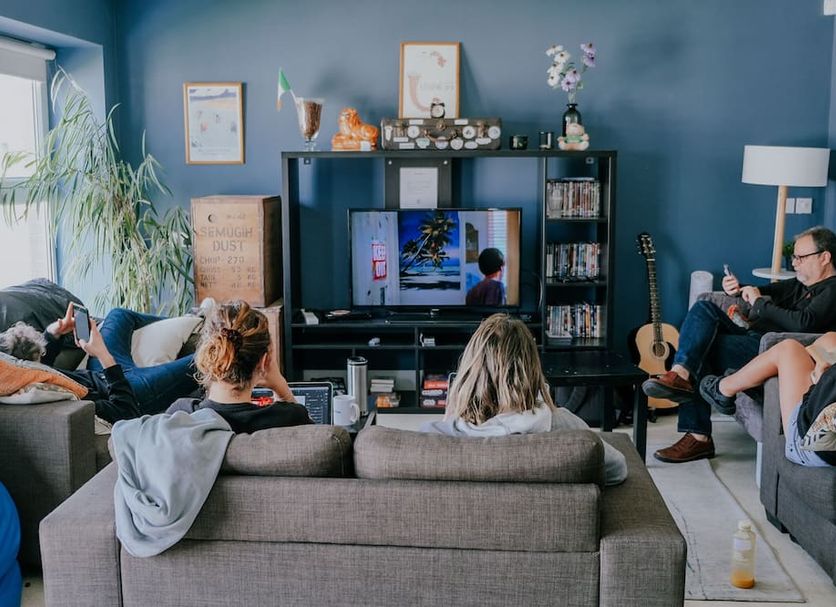 Garden Lane Backpackers in Dublin common lounge with guests watching TV and sitting on sofas