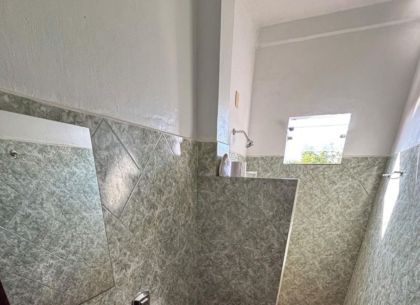 Hotel Chale Ji Parana bathroom with sink, toilet, tiled walls and small window in Ji-Paraná