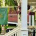 Ginkgo House on Harvard in Cambridge with hanging flower baskets and a green Ginkgo banner on a porch