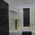 Margie Mykonos Hotel bathroom with bathtub, showerhead, tiled walls and vase of flowers in Mykonos