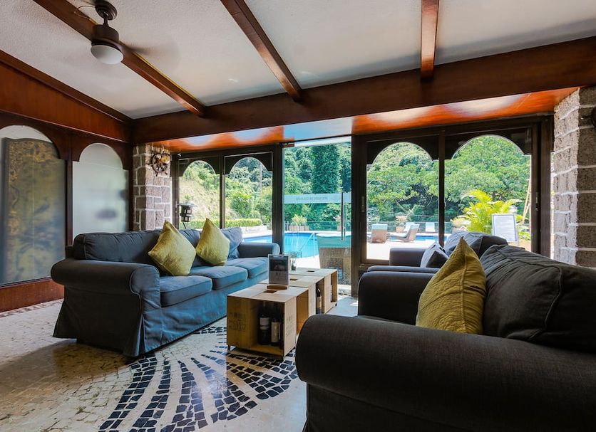 Pousada de Coloane Boutique Hotel in Macau lounge with sofas and pool view through arched windows