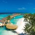 Atmosphere Kanifushi Maldives overwater villas, curved boardwalk and white-sand lagoon in Kanifushi
