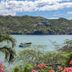 Hotel Bahia Taganga in Taganga with tropical garden and views of a calm bay and green hills