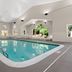 Country Inn & Suites by Radisson, Roanoke, VA indoor pool with lounge chairs and large windows