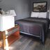 Essex Motel in Alturas guest room with double bed, nightstand, mini fridge and framed wall art
