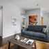 The Oxford at Pike Place Market Seattle: modern guest room with sofa, dining table and artwork