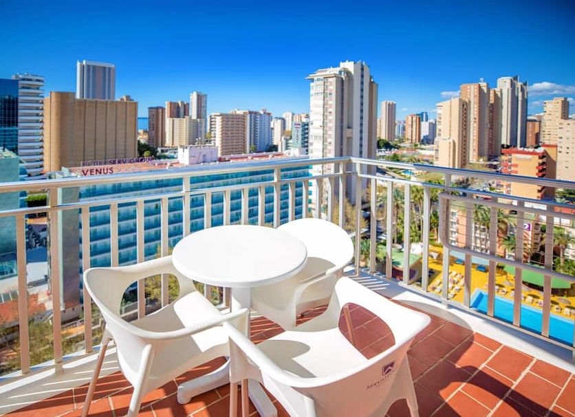 Hotel Servigroup Pueblo Benidorm balcony with table and chairs overlooking Benidorm skyline
