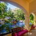 Barcelo Puerto Vallarta corridor with arches overlooking tropical gardens and a blue pool in Puerto Vallarta