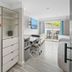 Costa Art Hotel in Laguna Beach room with open closet, desk, and balcony view