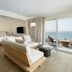 Pacific Edge Hotel in Laguna Beach suite with sofa facing ocean-view balcony and lounge chairs
