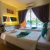 The Breath Khao Yai room in Mu Si with twin beds, balcony doors, and poolside views