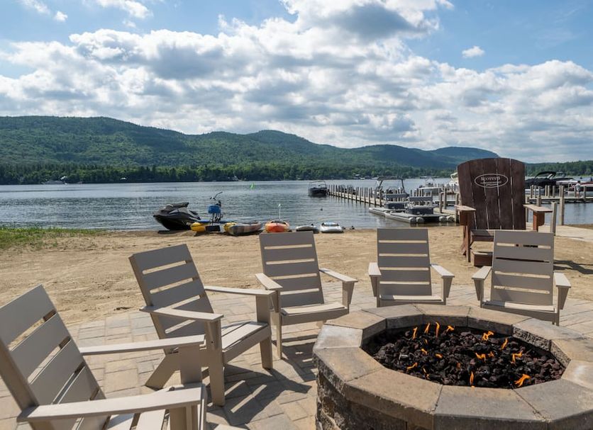 Scotty's Lakeside Resort in Lake George with Adirondack chairs and fire pit overlooking the lake