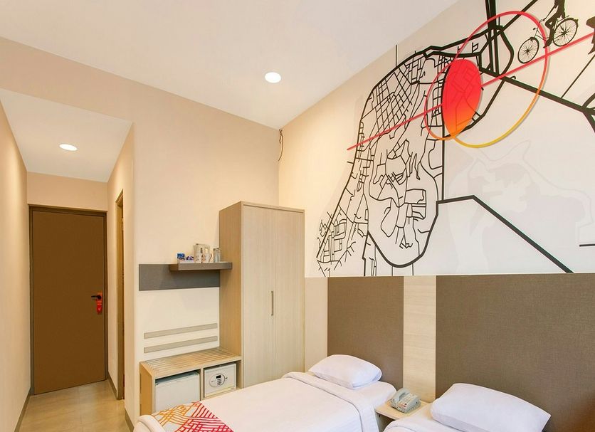 Ginger Bhubaneshwar room with twin beds and abstract wall art in Bhubaneswar