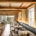 Banyan Tree Puebla restaurant interior with set tables, leather banquette seating, and stained glass windows