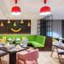 Holiday Inn Riyadh Al Malaz lounge with green sectional seating and red pendant lights in Riyadh