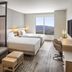 Hyatt Place South Reno guest room with two beds, sofa and mountain view in Reno