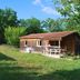 Lagrange Vacances Les Ségalières in Gramat, wooden cottage with porch in grassy garden