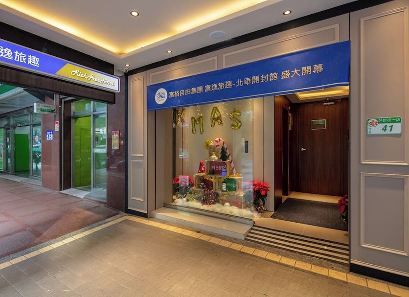 Rich & Free Hotel in Taipei City entrance with illuminated storefront and lobby display