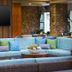 Hilton Garden Inn Kauai Wailua Bay lounge seating area with wicker sofas and wall-mounted TV in Kapaa
