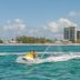 Margaritaville Beach Resort Grand Cayman in George Town with turquoise water and jet ski offshore