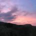 Casa Siciliana Altarbiah in Trabia with sunset sky over dark hills and coastline