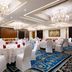 Ramada Encore by Wyndham Jalandhar banquet hall with round tables and white chair covers