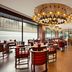 Ramada Encore by Wyndham Jalandhar restaurant dining area with chandeliers and modern seating
