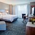 Courtyard by Marriott Pueblo Downtown guest room with king bed, seating area, desk, and large window