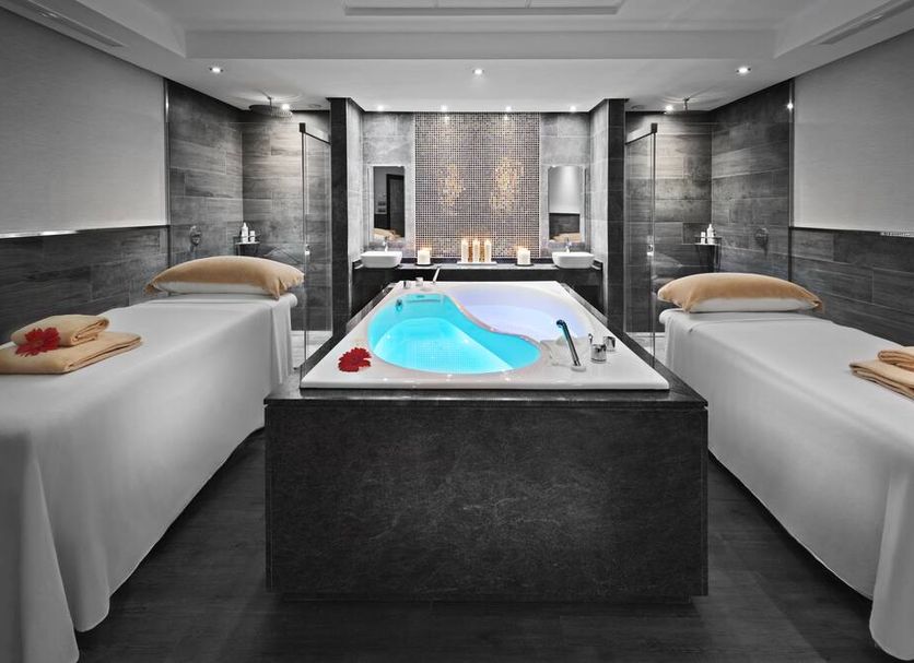Elba Lanzarote Royal Village Resort in Playa Blanca spa room with twin massage beds and central whirlpool tub