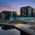 Delta Hotels by Marriott Thunder Bay waterfront hotel exterior at dusk with illuminated building and marina