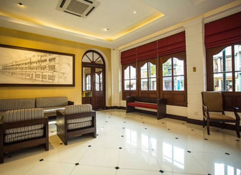 Hotel Nippon Colombo lobby with seating, arched windows and polished tile floor in Colombo