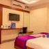 OYO 1594 Hotel Landmark Visakhapatnam room with wall-mounted TV and bed