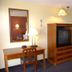Gulf Towers Resort Motel room in Indian Rocks Beach with TV cabinet, desk, mirror, and kitchenette