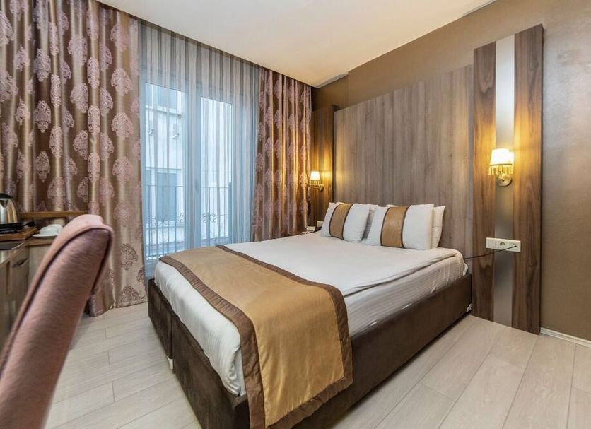Royal Capital Thermal & Spa Hotel in Bursa guest room with double bed and floor-to-ceiling curtains