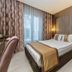 Royal Capital Thermal & Spa Hotel in Bursa guest room with double bed and floor-to-ceiling curtains