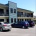 Abode On Courtenay Motor Inn in New Plymouth, two-story motel exterior with parked cars and balcony walkways