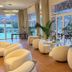 Hotel La Plantacion in Finestrat lounge with rounded chairs and large windows to the terrace