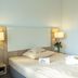 Hotel Kelkheimer Hof in Kelkheim guest room with double bed, bedside lamps and armchair
