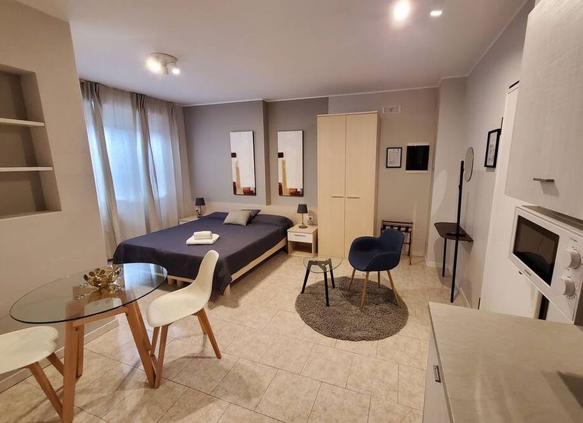 B&B Bonomelli Bergamo guest room with bed, desk, wardrobe, and seating area