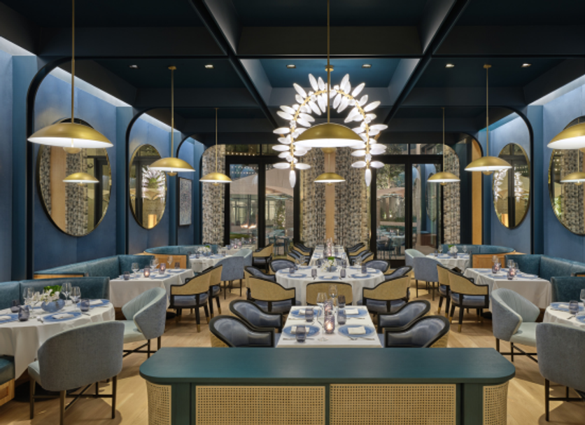 The Crescent Hotel, Fort Worth restaurant with blue booths, round tables, and pendant lights