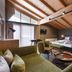 Familienparadies Sporthotel Achensee room in Achenkirch with wood سقiling, sofa, bed, and large window