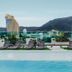 The Aim Patong Hotel rooftop pool with loungers and mountain views in Patong