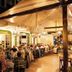 Hotel Peten in Flores outdoor dining area with guests seated under warm canopy lights