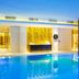 Hilton Kyiv indoor pool with blue-lit water and spa lounge area in Kyiv