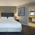 Delta Hotels by Marriott Waltham Abbey guest room with king bed and en suite bathroom