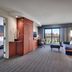 Courtyard by Marriott Johnson City suite with balcony view, sofa, desk and bedroom area