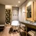 Meltar Boutique Hotel, Asiago: elegant bathroom with double sink vanity, freestanding tub and deer wall art