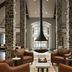 Inn at Bellefield / Hyde Park lounge with stone columns, leather chairs, and a central fireplace in Hyde Park